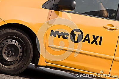 Close on the logo of a yellow NYC Taxi in New York Editorial Stock Photo