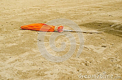 Close Orange umbrella on the sand Stock Photo