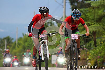 Close pictures of two cyclist keeping each other to reach the finish line Editorial Stock Photo