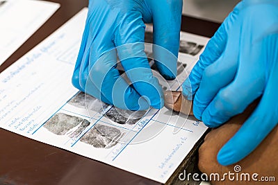 Wearing blue gloves, finger print, accused Stock Photo