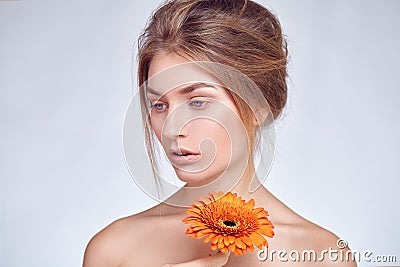 Close portrait of beautiful young girl with gerbera flower Stock Photo
