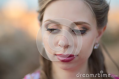 Close portrait of Pretty young blond lady woman with huge beautifull green eyes and pout red lips wearing dark pink dress.Make up Stock Photo