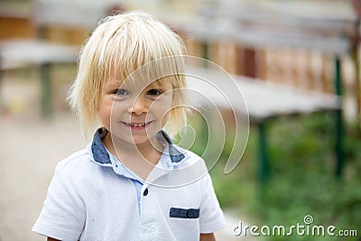 Close portrait of a smiling cute toddler child, beautiful blond boy, smiling at camera Stock Photo