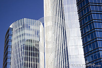 Close shot of a blue corporate building in front of its twin building. Stock Photo