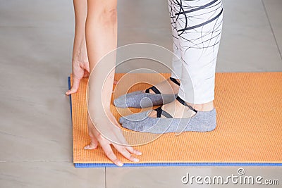 Close shot hands and feet of woman practice yoga indoor on mat Stock Photo