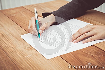 Close shot of a human hand writing contract Stock Photo