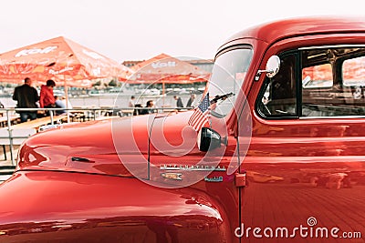 Close Side View Of Red International Harvester R-series Truck With Small American Flag Parked In Street. Editorial Stock Photo