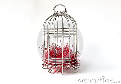 Close Steel Bird Cage with Pieces of Red Paper as Nest Isolated on White Background as Material for Valentine Event Stock Photo