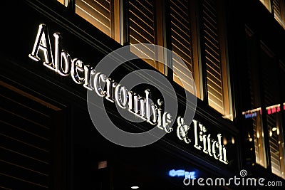 Close up Abercrombie Fitch logo on clothing store at night Editorial Stock Photo