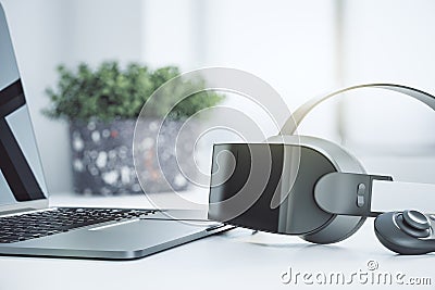 Close up of abstract VR glasses on blurry light office desk background with laptop keyboard and other items. Device and augmented Editorial Stock Photo