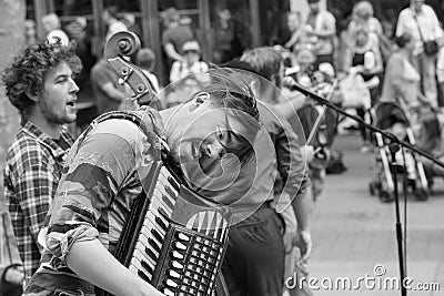 Accordionist Busking with a Band on a Street in York. Editorial Stock Photo