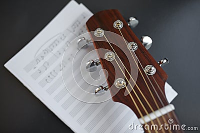 close up of acoustic guitar head with music book Stock Photo