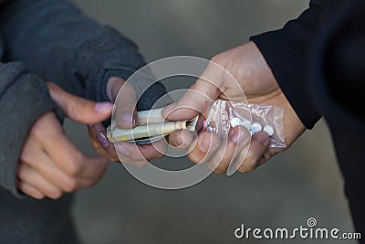 Close up of addict buying dose from drug dealer Stock Photo