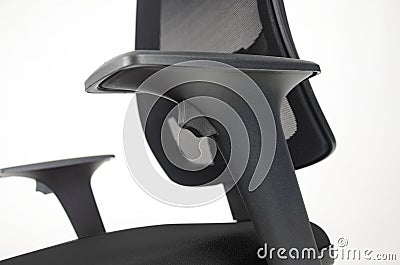 Close up on adjustable arm rest of black leather office chair. Isolated on white. Side view. Stock Photo