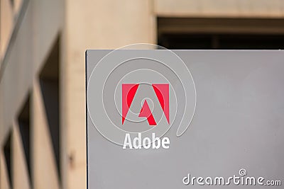 Close up. Adobe logo on signpost at Adobe Inc headquarters Editorial Stock Photo