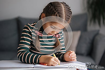 Close-up of adorable girl drawing. Creativity little girl painting at home. Stock Photo