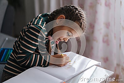 Close-up of adorable girl drawing. Creativity little girl painting at home. Stock Photo