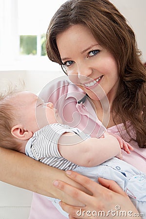 Close Up Of Affectionate Mother Cuddling Baby Boy Stock Photo