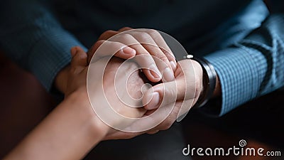 Close up African American man comforting woman, holding hands Stock Photo