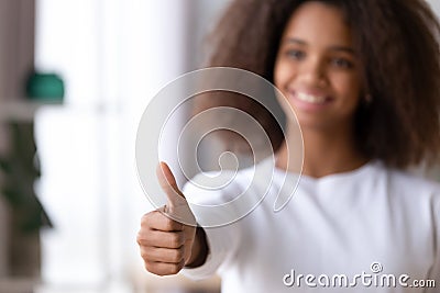 Close up African American teenage girl showing thumbs up, like Stock Photo