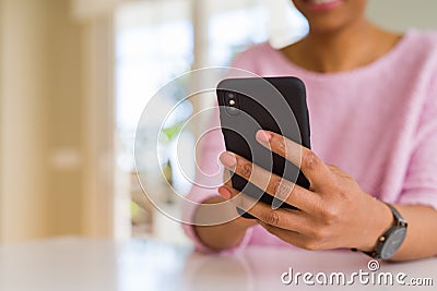 Close up of african american woman using smartphone and smiling Stock Photo