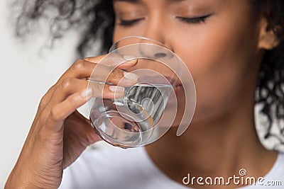 Close up african millennial female holding glass drinking water Stock Photo