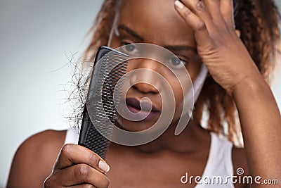 Shocked Woman Suffering From Hair Loss Problem Stock Photo