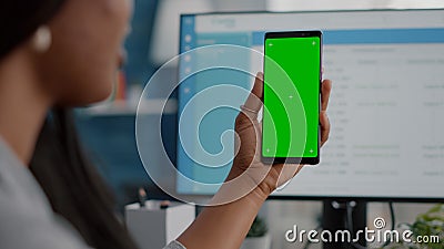 Close-up of african woman holding mock up green screen chroma key phone with isolated display Stock Photo