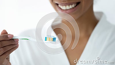 Closeup image african woman holding toothbrush with toothpaste Stock Photo