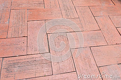 Close-up of an aged brick paved courtyard, a pattern of clay brick lay to for pattern zigzag style Stock Photo