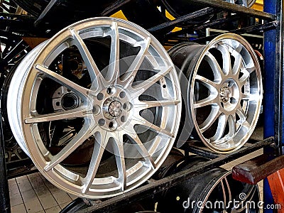 Close up of alloy wheels on shelves Stock Photo