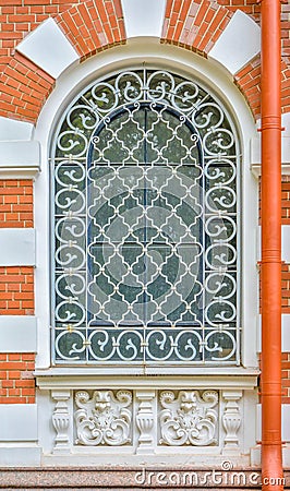 Close-up of ancient vintage arch window with cast iron white lattice, pattern Stock Photo