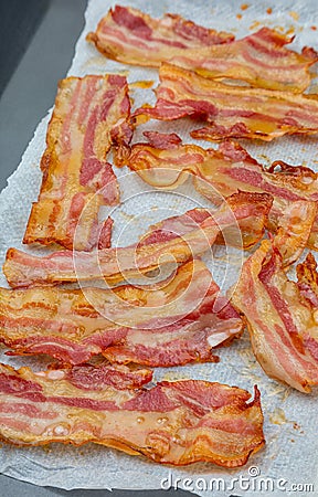 Close-up of appetizing slices of smoked bacon. Isolated on white background. Stock Photo