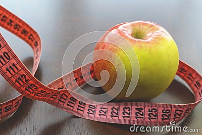 Close up apple, meter tape. Concept Healthy way of life Stock Photo