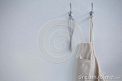 Apron and whisker hanging on hook Stock Photo