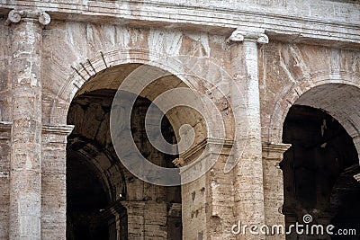 Close-up of the arches of the Colosseum with in the background the internal part of the walls soiled by the accumulation of dust Stock Photo