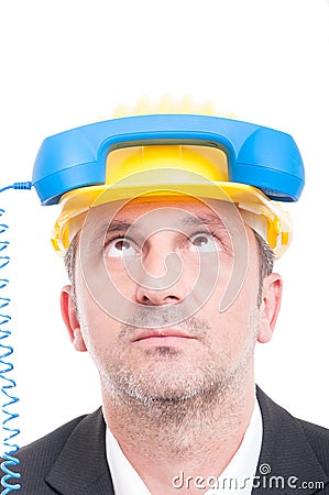 Close-up of architect acting silly with telephone receiver on hi Stock Photo