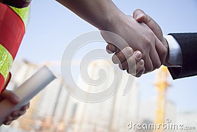Close up of architect and building contractor shaking hands Stock Photo