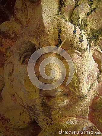 A close up of a stone Grotesque carved face Stock Photo