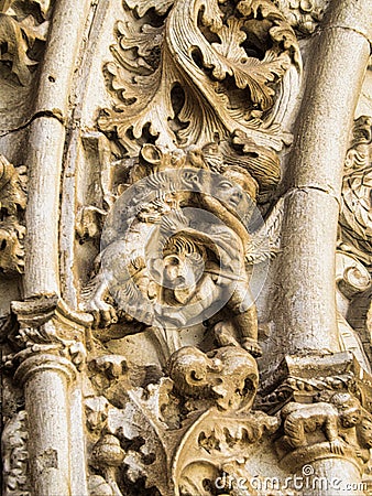 A close up of stone Grotesque carved face Stock Photo