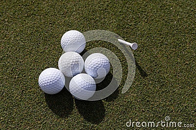 Close-up of an array of white golf balls on green grass Stock Photo