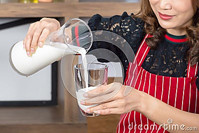 Close up, asian beautiful woman pouring milk Stock Photo