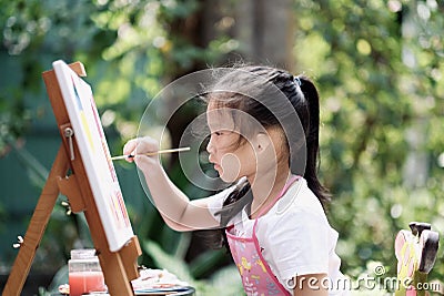 Close up of Asian child girl is painting on the canvas. Stock Photo