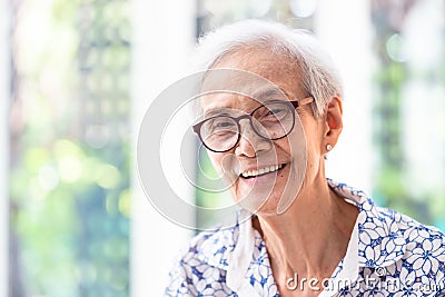 Close up asian elderly woman in glasses showing healthy straight teeth,portrait senior woman smiling feeling happy,beautiful Stock Photo