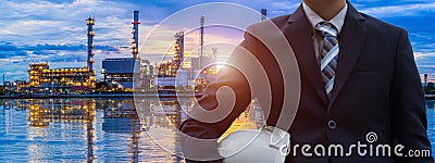 Close up of Asian engineers in front of the refinery. Stock Photo