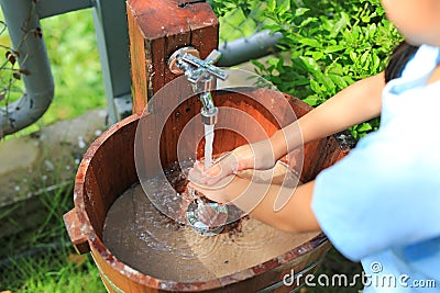 Close-up asian little child girl washing hands in water sinks Stock Photo