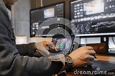 close-up of an Asian male movie video editor or coloris in his creative office studio. Stock Photo