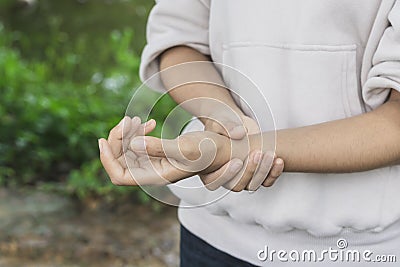 Close up Asian women painful hand in the garden Stock Photo