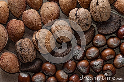 Close up of assortment nuts on a wooden table: wallnuts, almonds Stock Photo