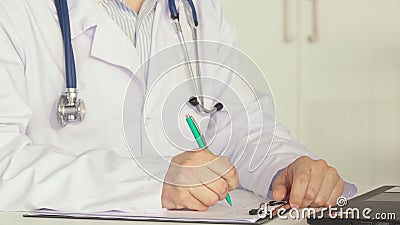 Male doctor working at the table Stock Photo